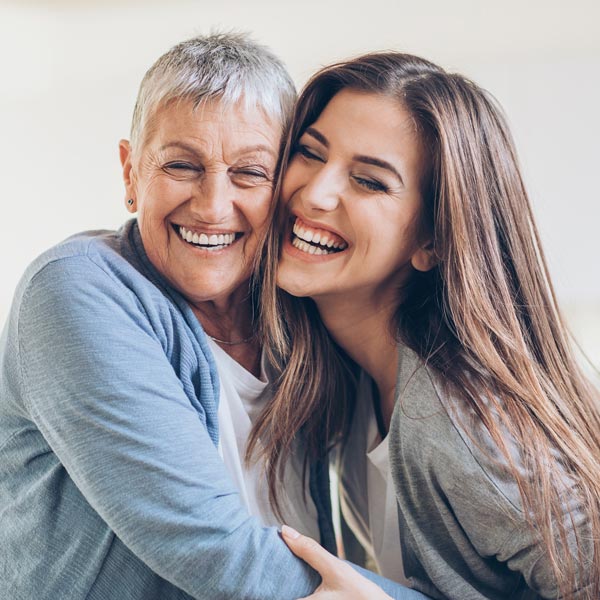 mother smiling with adult daughter