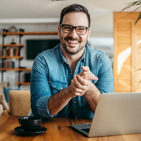 man with laptop smiling