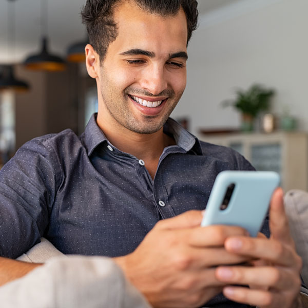 man smiling on cell phone