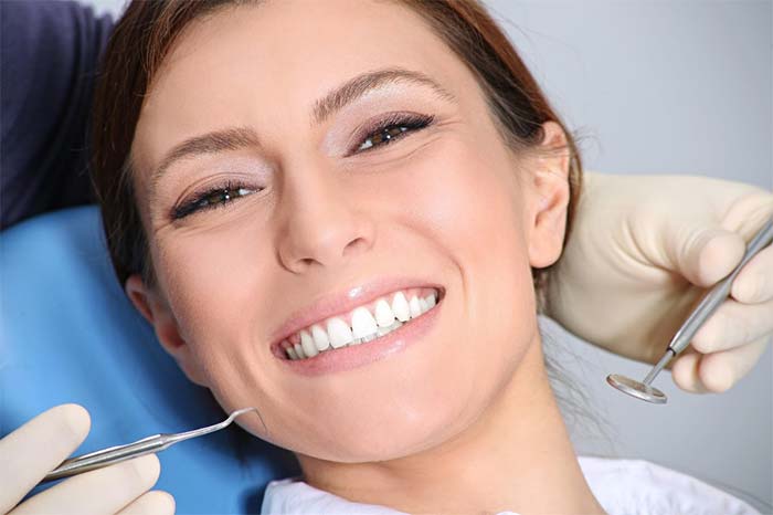 Women Smiling After Completing Her Dental Examination in Boise, ID

